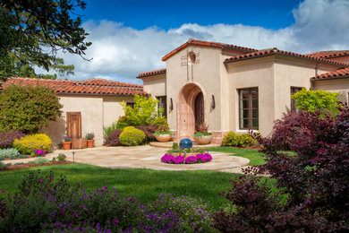 Tuscan beige one-story stucco house exterior photo in San Francisco with a hip roof and a tile roof