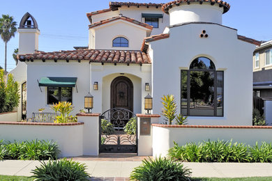 Large tuscan white three-story stucco house exterior photo in San Diego with a hip roof