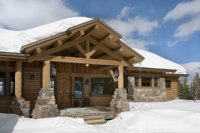 Large mountain style brown one-story wood house exterior photo in Other