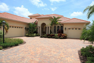 Inspiration for a mediterranean beige exterior home remodel with a tile roof