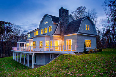 Inspiration for a large timeless blue three-story exterior home remodel in Boston with a gambrel roof