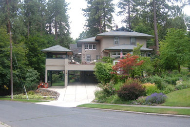 Large traditional gray two-story vinyl house exterior idea in Seattle with a clipped gable roof and a shingle roof