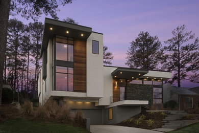 Inspiration for a large modern gray two-story stone flat roof remodel in Atlanta