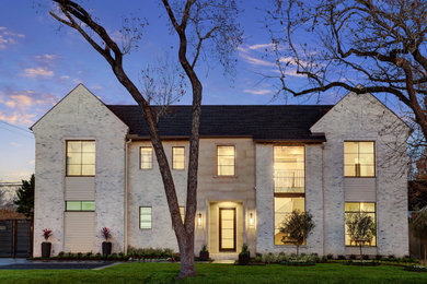 Example of a large transitional gray two-story brick exterior home design in Houston with a mixed material roof