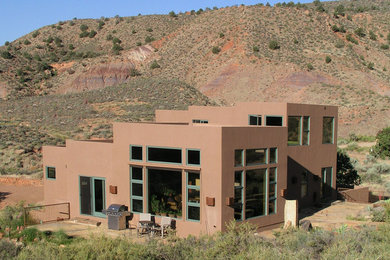 Inspiration for a mid-sized southwestern brown three-story stucco exterior home remodel in Salt Lake City
