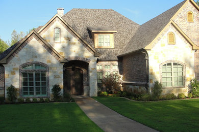 Mid-sized traditional multicolored two-story mixed siding exterior home idea in Dallas with a shingle roof