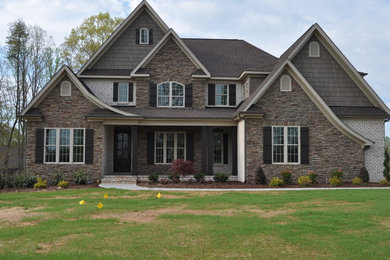 This is an example of a beige traditional brick house exterior in Raleigh.