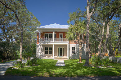 Mid-sized beach style two-story mixed siding exterior home photo in Jacksonville with a hip roof