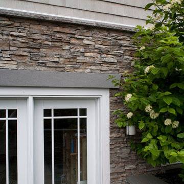 Stacked Stone Exterior and White Window Trimming