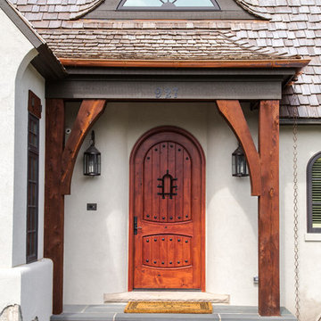Stained Knotty Alder Arched Top Front Door with Eyebrow Dormer & Cedar Post