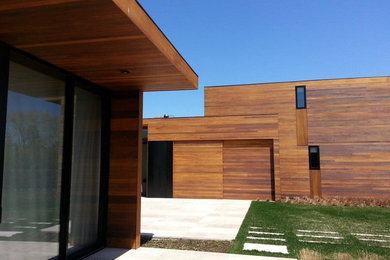 Large minimalist brown two-story wood exterior home photo in New York