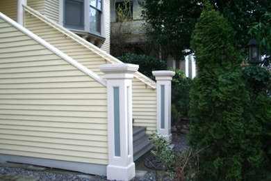 Inspiration for a yellow two-story vinyl exterior home remodel in Seattle