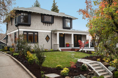 Large elegant gray two-story wood house exterior photo in Seattle with a hip roof and a shingle roof
