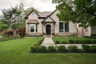 Medium sized and beige classic two floor house exterior in Dallas with stone cladding and a pitched roof.