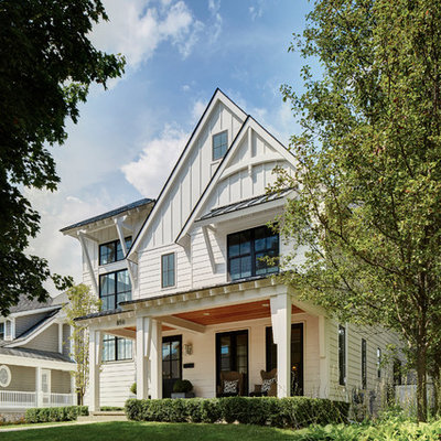 Example of a large transitional white two-story concrete fiberboard gable roof design in Detroit