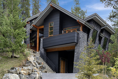 Large contemporary black two-story mixed siding exterior home idea in Vancouver with a shingle roof
