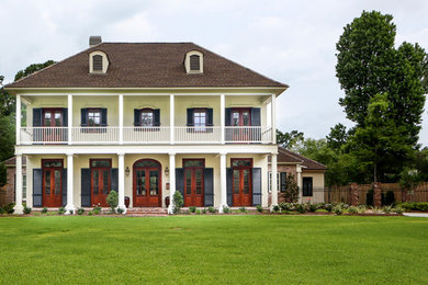 Inspiration for a mid-sized timeless white two-story brick gable roof remodel in New Orleans