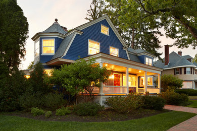 Example of a mid-sized arts and crafts blue three-story house exterior design in Boston with a shingle roof