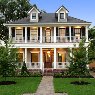 Großes, Zweistöckiges, Beigefarbenes Klassisches Haus mit Holzfassade, Walmdach und Dachgaube in Houston