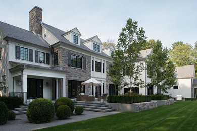 Inspiration for a large white two-story mixed siding exterior home remodel in New York with a shingle roof