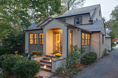 Mid-sized traditional gray two-story stucco exterior home idea in Baltimore with a hip roof