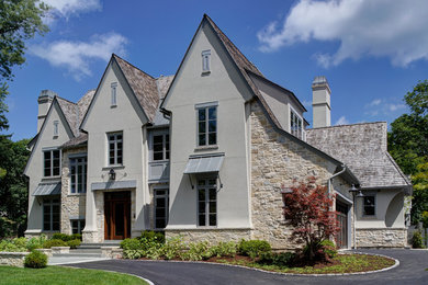 Example of a transitional beige two-story gable roof design in Chicago with a shingle roof