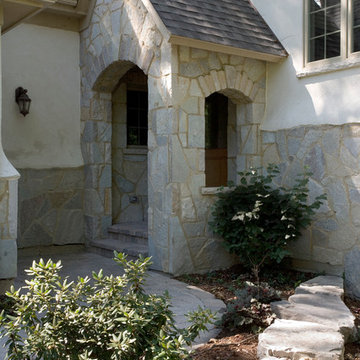 Stone and Stucco French Country Vacation Home Featuring Arch Top Stone Covered E