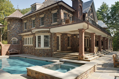 Inspiration for a large timeless brown three-story stone gable roof remodel in New York