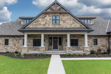 Inspiration for a large craftsman two-story stone house exterior remodel in Other with a shingle roof
