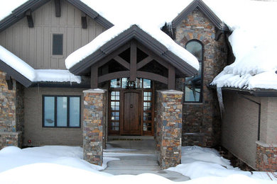 Example of a large brown two-story mixed siding exterior home design in Salt Lake City with a hip roof