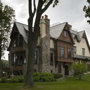 Stone, Stucco and Cedar Chateau with Clay Chimney Pots and Batten Details