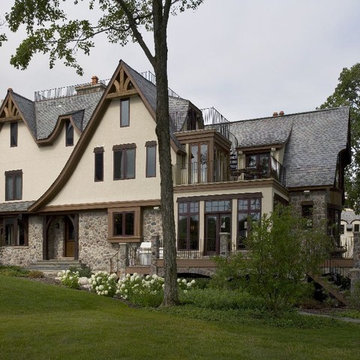 Stone, Stucco and Cedar Chateau with Graduated Slate Tile Roof and Rustic Timber