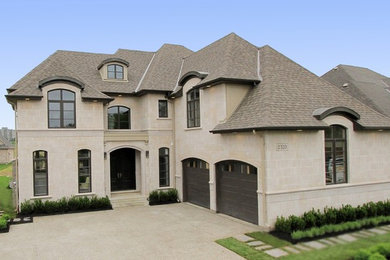 Large beige two-story stone exterior home photo in Toronto