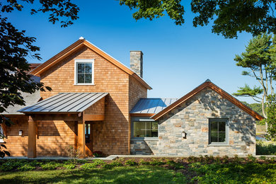 Inspiration for a mid-sized transitional brown two-story wood exterior home remodel in Other with a mixed material roof
