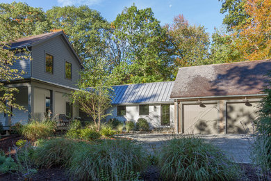 Inspiration for a country gray wood house exterior remodel in New York with a shingle roof