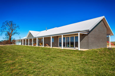 This is an example of a farmhouse house exterior in Canberra - Queanbeyan.