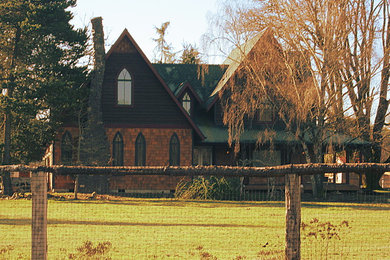 Example of a mid-sized country two-story exterior home design in Portland