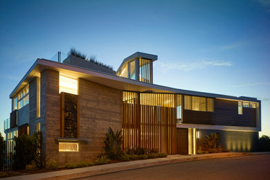 Large minimalist multicolored three-story mixed siding exterior home photo in Los Angeles with a mixed material roof