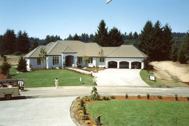 Example of a trendy one-story stucco exterior home design in Seattle