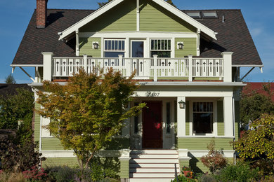 Mid-sized elegant green two-story wood gable roof photo in Seattle
