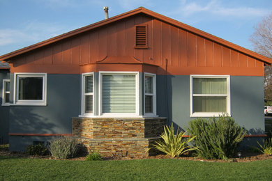 Photo of a medium sized and blue traditional bungalow house exterior in Los Angeles with mixed cladding and a pitched roof.