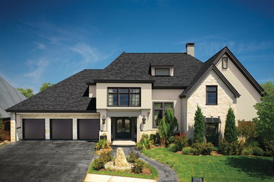 Example of a large transitional white two-story stucco house exterior design in Atlanta with a hip roof and a shingle roof