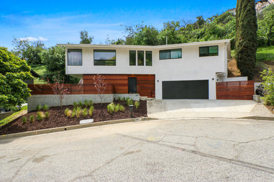 Example of a trendy white two-story wood house exterior design in Los Angeles