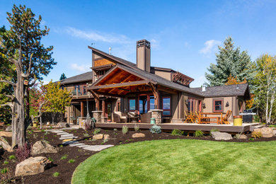 Example of a large mountain style one-story house exterior design in Portland