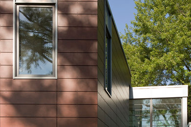 Modelo de fachada marrón moderna de tamaño medio de dos plantas con tejado plano