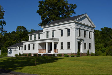 Idée de décoration pour une grande façade de maison blanche champêtre en bois à un étage.