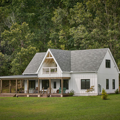 Example of a small cottage white two-story exterior home design in Other with a shingle roof