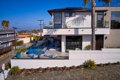 Mid-sized minimalist white three-story stucco exterior home photo