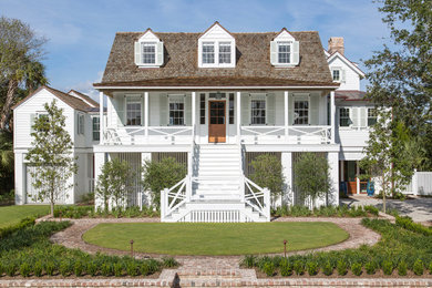 Coastal white three-story wood exterior home idea in Charleston