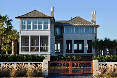 Inspiration for a coastal white two-story mixed siding exterior home remodel in Charleston with a hip roof